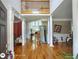 Grand foyer with hardwood floors, soaring ceilings, elegant columns, and a glimpse of the living spaces at 1292 Hidden Spirit Trl, Lawrenceville, GA 30045