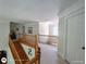 Upstairs hallway featuring a staircase, wooden railing, and multiple rooms at 1292 Hidden Spirit Trl, Lawrenceville, GA 30045