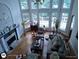 Sun-filled living room boasting hardwood floors, large windows, and a cozy fireplace at 1292 Hidden Spirit Trl, Lawrenceville, GA 30045