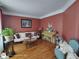 Comfortable living room featuring hardwood floors, a cream-colored sofa, and a bright, airy feel at 1292 Hidden Spirit Trl, Lawrenceville, GA 30045