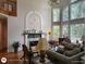 Cozy living room with a fireplace, hardwood floors, and large windows at 1292 Hidden Spirit Trl, Lawrenceville, GA 30045