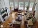 Sun-filled living room boasting hardwood floors, large windows, and a cozy fireplace at 1292 Hidden Spirit Trl, Lawrenceville, GA 30045