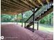 View of the brick patio with steps leading up to the deck and the lush green yard in the background at 1292 Hidden Spirit Trl, Lawrenceville, GA 30045