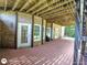 Covered brick patio with white French doors leading into the house and dark painted support columns at 1292 Hidden Spirit Trl, Lawrenceville, GA 30045