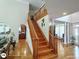 Grand staircase with hardwood steps, white risers, and elegant wooden railing at 1292 Hidden Spirit Trl, Lawrenceville, GA 30045