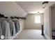 Large walk-in closet with carpet flooring, window, and plentiful storage at 1292 Hidden Spirit Trl, Lawrenceville, GA 30045