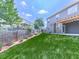 Fenced backyard with lush lawn, landscaping, and a charming patio area at 212 Torch Dr, Acworth, GA 30102