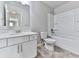 Bathroom featuring a tub, white cabinets, sink, and tile floors at 212 Torch Dr, Acworth, GA 30102