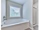 Bright bathroom featuring a separate shower and tub, window and neutral colors at 212 Torch Dr, Acworth, GA 30102
