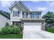Charming two-story home with a stone-accented facade, well-manicured lawn, and a two-car garage at 212 Torch Dr, Acworth, GA 30102