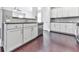 Stylish kitchen with white cabinetry, stainless steel appliances, and a view into the adjacent living space at 212 Torch Dr, Acworth, GA 30102
