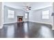 Bright and airy living room featuring a stone fireplace, hardwood floors, and large windows at 212 Torch Dr, Acworth, GA 30102