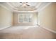 Primary bedroom features carpet, ceiling fan, tray ceiling and a wall of windows at 620 Willow Haven Way, Suwanee, GA 30024