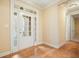 Hardwood foyer featuring a decorated front door with sidelights and two interior doors at 620 Willow Haven Way, Suwanee, GA 30024