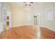 Open-concept living room with hardwood floors, neutral walls, and multiple entryways to other rooms at 620 Willow Haven Way, Suwanee, GA 30024
