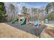 Community playground with slides and swings and the McGinnis Reserve sign at 620 Willow Haven Way, Suwanee, GA 30024