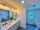 Bright bathroom featuring double vanity, quartz countertops, and modern fixtures at 6751 Davidson Ct, Lithonia, GA 30058