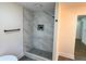 Bathroom shower with grey and white marble tile surround and custom fixtures at 6751 Davidson Ct, Lithonia, GA 30058