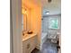 Stylish bathroom featuring a modern vanity and luxurious marble-tiled shower and tub at 6751 Davidson Ct, Lithonia, GA 30058