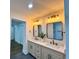 Bathroom featuring double vanity, quartz countertops, and modern fixtures at 6751 Davidson Ct, Lithonia, GA 30058