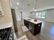 Open kitchen showcasing a spacious island, and stainless-steel appliances at 6751 Davidson Ct, Lithonia, GA 30058