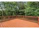Inviting back deck with wood flooring overlooks a lush backyard at 1240 Rocky Rd, Lawrenceville, GA 30044