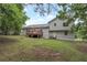 Expansive backyard view of the deck and house with lush green lawn and mature trees at 1240 Rocky Rd, Lawrenceville, GA 30044