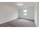This bedroom features soft carpeting and a light-filled window to enjoy nature views at 1240 Rocky Rd, Lawrenceville, GA 30044