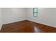 Cozy bedroom with hardwood floors, a window offering natural light, and neutral wall colors at 1240 Rocky Rd, Lawrenceville, GA 30044