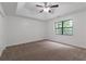 An airy bedroom featuring plush carpeting, a ceiling fan, and a light-filled window at 1240 Rocky Rd, Lawrenceville, GA 30044