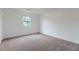 This bedroom features soft carpeting and a light-filled window at 1240 Rocky Rd, Lawrenceville, GA 30044