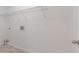 This laundry room features tile flooring, white walls, and a metal storage shelf at 1240 Rocky Rd, Lawrenceville, GA 30044