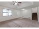Bright living room featuring wainscoting, large windows, and a staircase at 1240 Rocky Rd, Lawrenceville, GA 30044