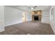 Cozy living room with a stone fireplace, built-in bookshelves, and neutral carpet at 1240 Rocky Rd, Lawrenceville, GA 30044