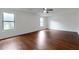 Bright, expansive living room with beautiful hardwood floors and natural light from large windows at 1240 Rocky Rd, Lawrenceville, GA 30044
