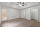 Spacious bedroom features plush carpet, ensuite bath, walk-in closet, and trey ceiling at 1240 Rocky Rd, Lawrenceville, GA 30044