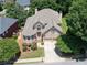 Stunning aerial view of a well-maintained brick home with lush landscaping and mature trees in a serene neighborhood at 2002 Ivy Ridge Se Rd, Smyrna, GA 30080