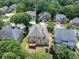 Aerial perspective showcasing a large home with a back deck and a private, tree-lined yard at 2002 Ivy Ridge Se Rd, Smyrna, GA 30080
