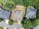 An aerial shot displaying a home with tidy landscaping surrounded by lush greenery and neighboring residences at 2002 Ivy Ridge Se Rd, Smyrna, GA 30080