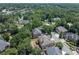 An aerial view shows a suburban neighborhood with mature trees and well-maintained homes at 2002 Ivy Ridge Se Rd, Smyrna, GA 30080