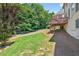 Expansive backyard with lush lawn, mature trees, and a charming wooden deck, perfect for outdoor enjoyment at 2002 Ivy Ridge Se Rd, Smyrna, GA 30080