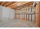 Unfinished basement with concrete floor, wood framing, and exposed utilities at 2002 Ivy Ridge Se Rd, Smyrna, GA 30080