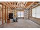 Unfinished basement space with concrete floor, wood framing, and ample natural light at 2002 Ivy Ridge Se Rd, Smyrna, GA 30080