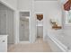 Bright bathroom boasts double doors to shower and bath with tile flooring at 2002 Ivy Ridge Se Rd, Smyrna, GA 30080
