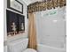Clean bathroom features a decorative shower curtain, a white tub, and modern fixtures at 2002 Ivy Ridge Se Rd, Smyrna, GA 30080