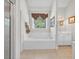 Bright bathroom features a soaking tub under a window and a separate vanity at 2002 Ivy Ridge Se Rd, Smyrna, GA 30080