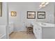 Bright bathroom features a soaking tub and vanity with white cabinetry at 2002 Ivy Ridge Se Rd, Smyrna, GA 30080