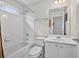 Bright bathroom features a shower/tub combo, white cabinetry, and modern fixtures at 2002 Ivy Ridge Se Rd, Smyrna, GA 30080