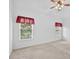 Bright bedroom features neutral carpet, a ceiling fan, and two large windows at 2002 Ivy Ridge Se Rd, Smyrna, GA 30080