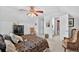 Bright bedroom features a unique ceiling fan, armoire, rocking chair, and attractive decor at 2002 Ivy Ridge Se Rd, Smyrna, GA 30080